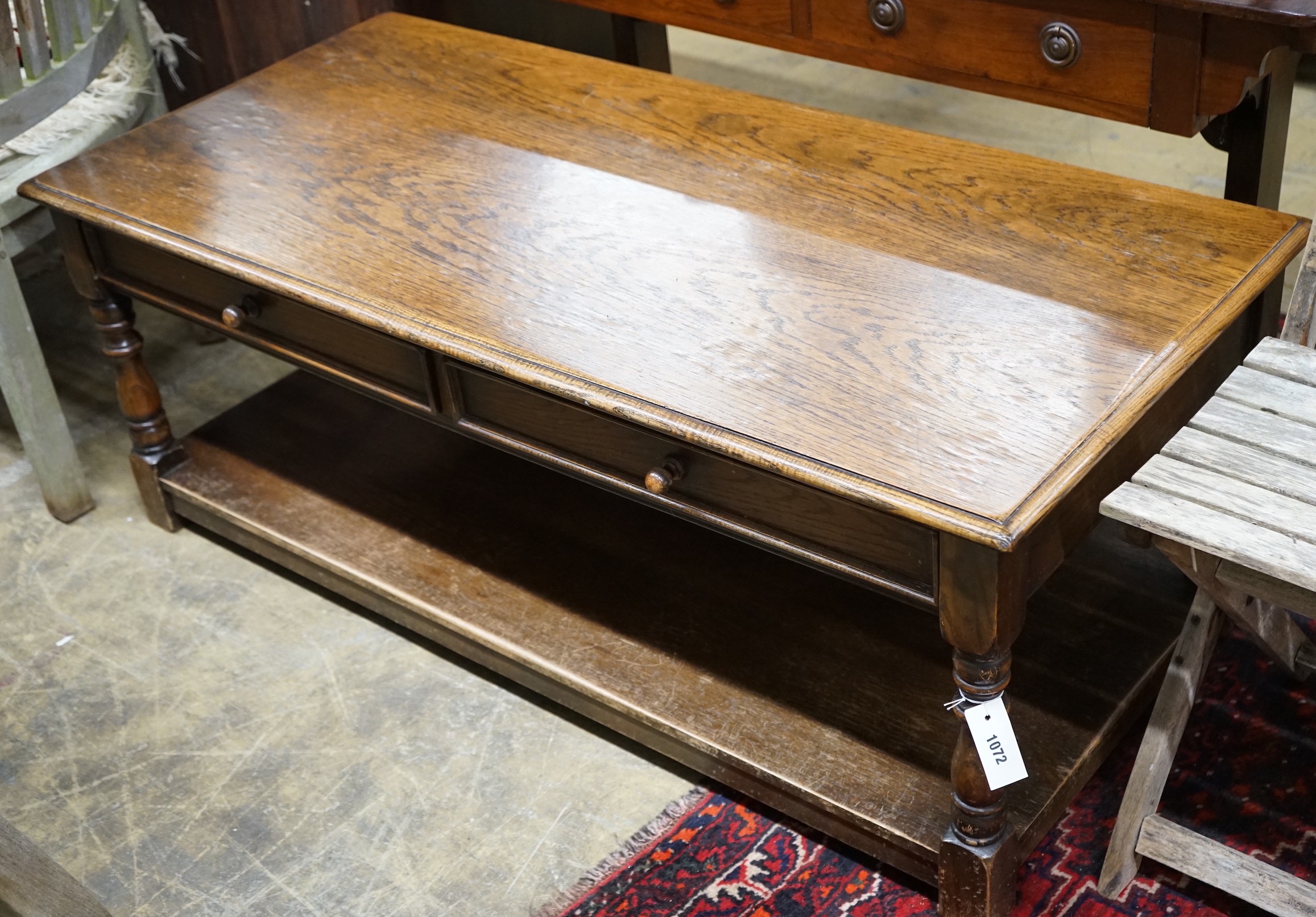 An 18th century style rectangular oak two tier coffee table, length 130cm, depth 62cm, height 50cm